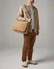 A man is posing with a messenger bag. Anteprima dell’immagine prodotto
