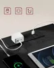 Close-up of a black power strip on a wooden desk with a phone and tablet charging. Náhled obrázku produktu