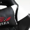 A close-up of a black and white gaming chair with red embroidered details. Produktbild-Vorschau