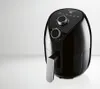 A black air fryer is shown against a white and light gray background. Produktbild-Vorschau