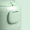 A close-up shot of a mint green mini rice cooker, focusing on the lid and a small handle. Produktbild-Vorschau