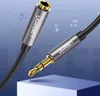 A close-up shot of a Ugreen audio cable adapter with a blue and white background with musical notes. Produktbild-Vorschau