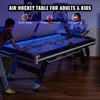 Two people playing an air hockey table in a room with ambient lighting. Anteprima dell’immagine prodotto