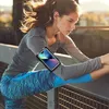 A woman is stretching her leg while wearing a sports armband with a phone on her arm. Náhled obrázku produktu