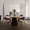 A dining table and chairs set in a room with an open doorway leading to a bedroom. Produktbild-Vorschau