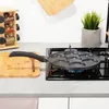 A multi-mold frying pan sits on a gas stove, with a spice rack and cutting board visible in the background. Produktbild-Vorschau