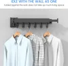 A wall-mounted drying rack with clothes hanging on it. Produktbild-Vorschau