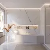A modern, minimalist bathroom with a white bathtub, marble walls, and a large window. Produktbild-Vorschau
