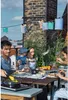 A family enjoying an outdoor barbecue on a rooftop. Podgląd zdjęcia produktu