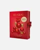 A red box with Christmas ornaments arranged in the shape of a Christmas tree, with text and a price tag. Produktbild-Vorschau