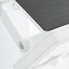 A close-up view of a white solar-powered outdoor light fixture, showing the adjustable solar panel and a mounting bracket with a screw. Produktbild-Vorschau