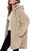 A woman wearing a beige sherpa jacket and a cream sweater. Produktbild-Vorschau