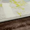 A close-up view of a rug's edge on a wooden floor. Produktbild-Vorschau
