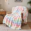 A plush blanket draped over a chair in a living room setting. Produktbild-Vorschau