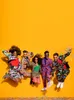 Five people in colorful, patterned suits jumping in the air against a bright yellow background. Anteprima dell’immagine prodotto