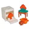 A set of toy kitchen accessories, including a toy oven with a flame inside, a small table with a campfire, a pot, and a toy chicken. Produktbild-Vorschau