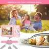 A family is shown enjoying themselves outdoors, with a pink digital camera in the foreground. Produktbild-Vorschau