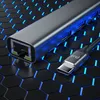 A close-up shot of a USB-C hub with an Ethernet port and a USB-C cable, set against a dark, hexagonal background with blue light accents. Produktbild-Vorschau
