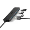 A black USB hub with several USB drives plugged into it, shown on a white background. Produktbild-Vorschau