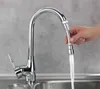 A hand is holding a flexible faucet hose with water running through it into a sink. Produktbild-Vorschau