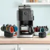A coffee maker with cups and saucers on a kitchen counter. Produktbild-Vorschau