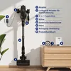A cordless vacuum cleaner is mounted on a wall with various accessories and a manual displayed on a wooden cabinet. Produktbild-Vorschau
