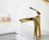 A gold-colored faucet with water running into a sink, with decorative pearls and a crown-like object in the background. Produktbild-Vorschau