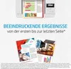 A printer is shown printing a document with charts and graphs, with marketing brochures displayed below. The overall scene is a promotional display for printing services or products. Produktbild-Vorschau