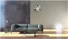 A living room scene with a sofa, coffee table, lamp, and a decorative clock on the wall. Anteprima dell’immagine prodotto
