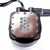 A close-up, top-down view of a computer water cooling pump with a copper plate featuring a hexagonal pattern. Náhled obrázku produktu