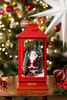 A festive Christmas scene with a red lantern containing a Santa Claus figurine, set against a decorated Christmas tree. Produktbild-Vorschau