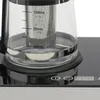 Close-up of a glass tea maker with measurement markings on the side, placed on a black base with touch controls. Podgląd zdjęcia produktu