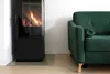 A modern living room scene with a fireplace and a sofa. Produktbild-Vorschau