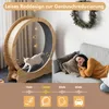A cat is running on a wooden wheel, while a woman sleeps on a couch nearby. The image is split into two sections, with the cat wheel on the left and the sleeping woman on the right. Below the images, there are icons and text related to noise levels. Voir les images du produit