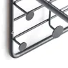 A close-up of a black metal coat rack with a white background. Voir les images du produit