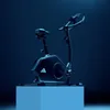 An Adidas exercise bike is displayed on a blue pedestal against a dark blue background. Produktbild-Vorschau