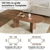 An oval dining table with two pedestal legs, shown in a dining room setting with a rug underneath and a cabinet in the background. Text overlays describe the table's dimensions and seating capacity. Náhľad obrázku produktu
