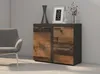 A modern sideboard with a rustic wood front and a dark gray top and sides, placed in a room with a gray wall and a gray armchair. Náhled obrázku produktu