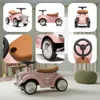 A collage of images showing a pink ride-on car from various angles and close-ups, with one image showing the car in a room setting. Produktbild-Vorschau