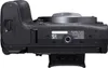 A close-up, top-down view of a black Canon camera, showing the battery and card compartment, and some labeling. Náhľad obrázku produktu