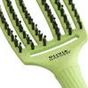 A close-up of a green hairbrush. Anteprima dell’immagine prodotto