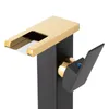 A close-up studio shot of a modern black and gold faucet. Podgląd zdjęcia produktu