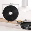 A close-up of a round charcoal filter for a range hood, with dimensions indicated. In the background, a kitchen scene with a stove and pots. Produktbild-Vorschau
