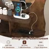 A close-up view of a wooden vanity table with an integrated charging station, featuring a phone and smartwatch charging, along with electrical outlets and USB ports. Podgląd zdjęcia produktu