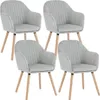 Four light gray upholstered dining chairs with wooden legs are arranged in a grid formation against a white background. Náhľad obrázku produktu
