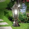 A garden lamp is shown in a garden setting with a stone path and a cherub statue. Produktbild-Vorschau