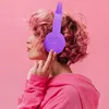 A person with pink hair wearing purple headphones and a pink hoodie against a pink background. Náhľad obrázku produktu