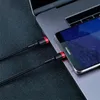 A close-up shot of two black and red USB-C cables plugged into a laptop and a smartphone. Podgląd zdjęcia produktu