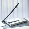 A paper cutter is shown on a desk with a cutting mat. Produktbild-Vorschau