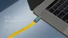 A yellow USB-C cable plugged into a laptop. Anteprima dell’immagine prodotto
